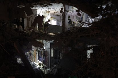 Israeli troops check a building hit by a missile fired from Iran.